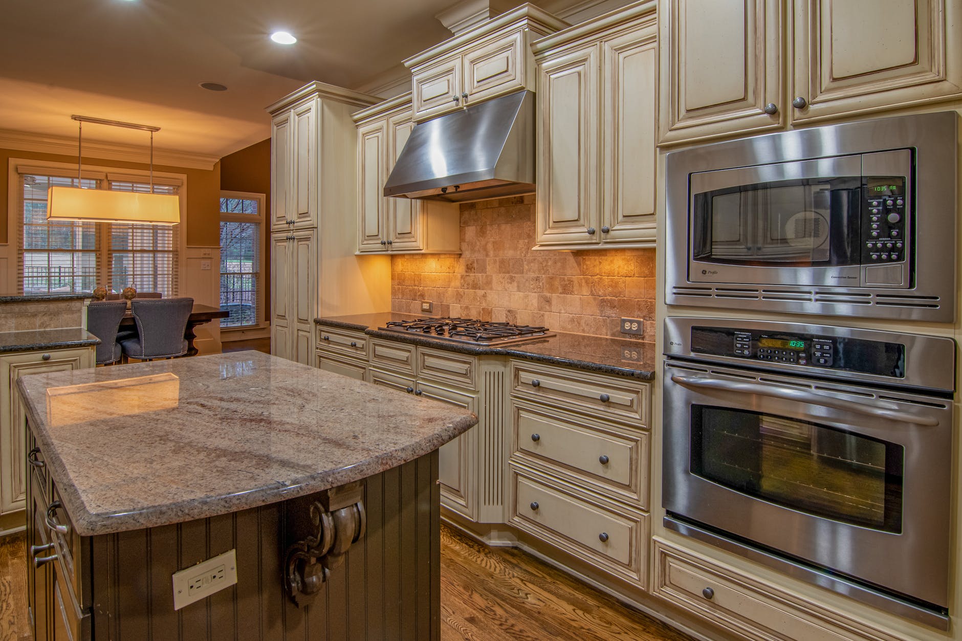 silver microwave oven on brown wooden kitchen cabinet