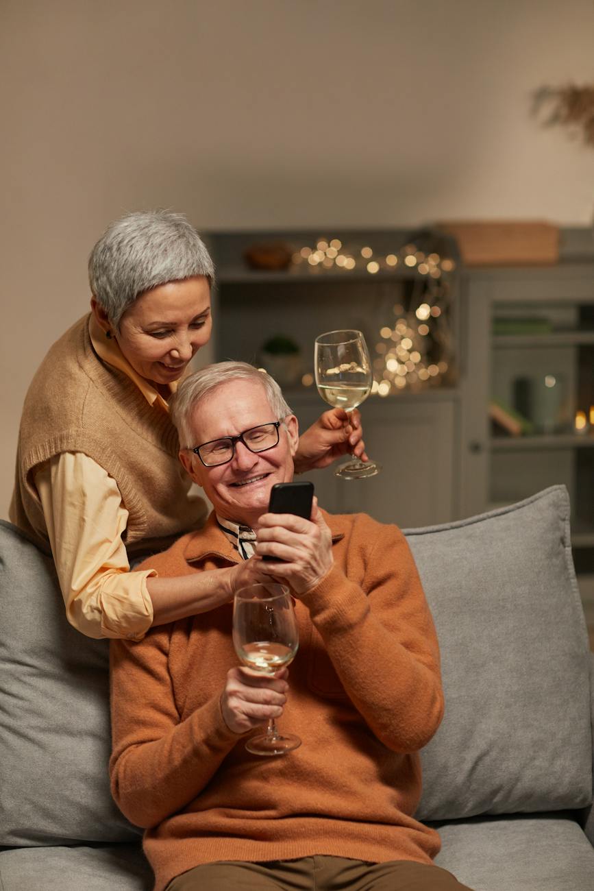 couple smiling while looking at a smartphone