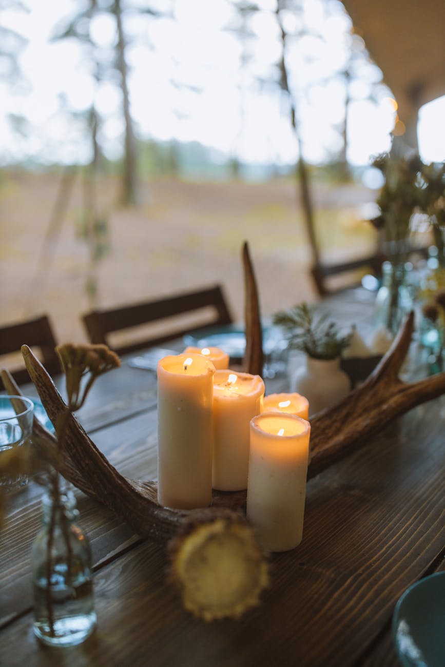 white pillar candles on brown wooden table